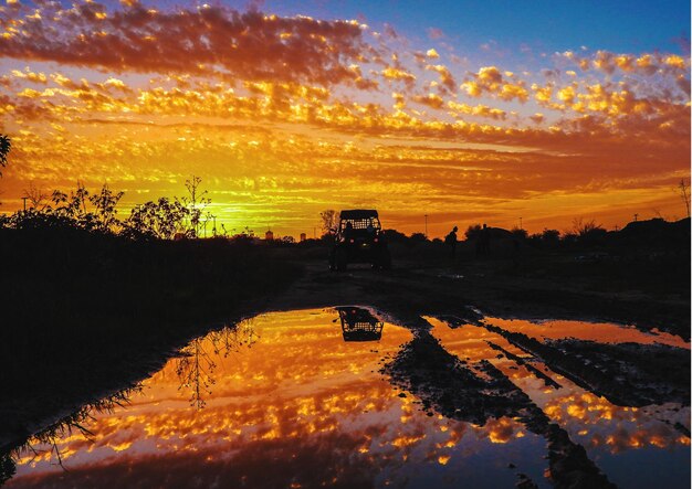 Scenic view of field against sky during sunset