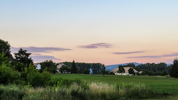 Scenic view of field against sky during sunset