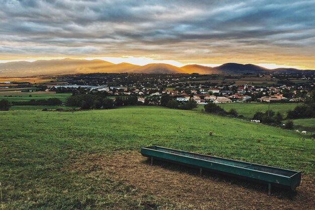 Scenic view of field against sky at sunset