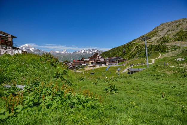 Scenic view of field by buildings against sky