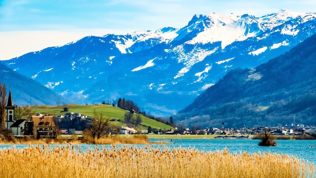 Scenic view of field by mountains against sky