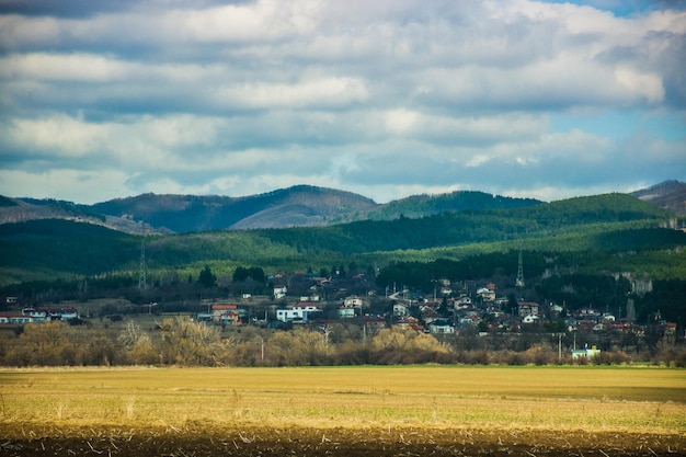 Scenic view of field and mountains against sky