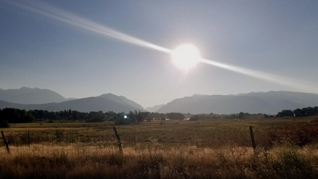 Scenic view of field and mountains against sky