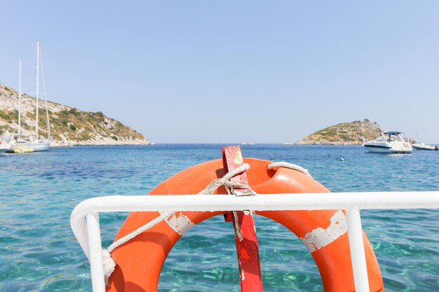 Scenic view from boat with lifebelt of sea against clear sky