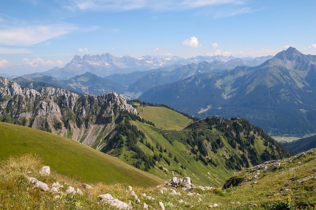 A scenic view from the mountains with the grass below it