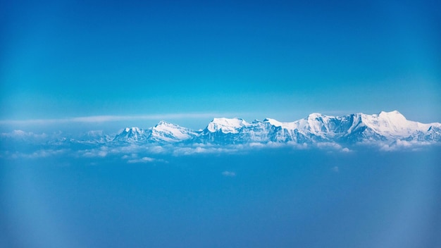 Scenic view of frozen lake against clear blue sky