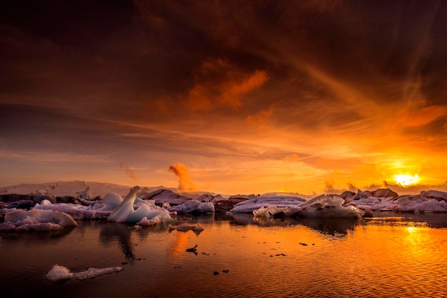 scenic view of frozen lake against sky during sunset