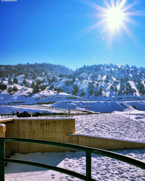 Scenic view of frozen mountains against sky