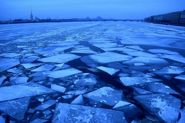 Scenic view of frozen river against blue sky