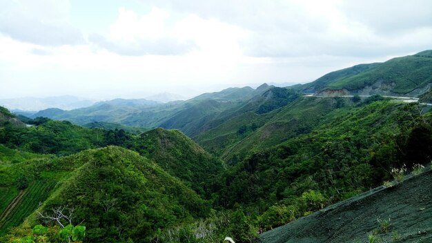 Scenic view of green mountains against sky