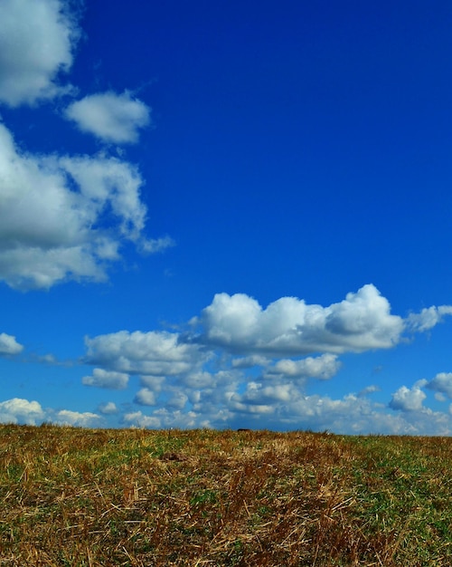 Scenic view of hill against cloudy sky