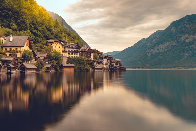 Scenic view of houses by lake against sky during sunset