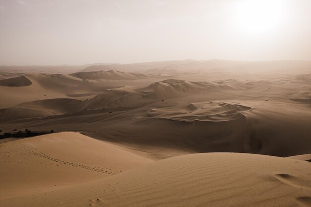 Photo scenic view of huacachina desert against sky