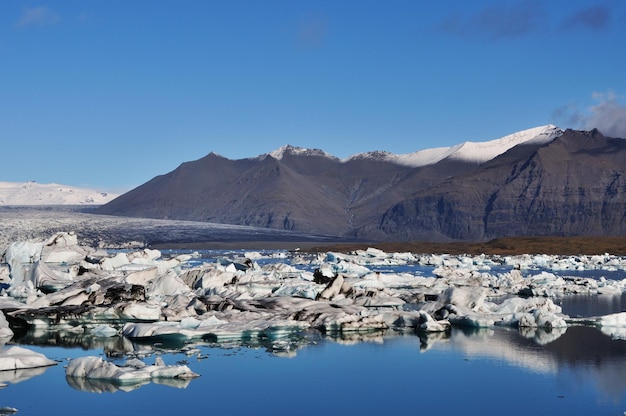 Scenic view of ice floe in lake against mountains