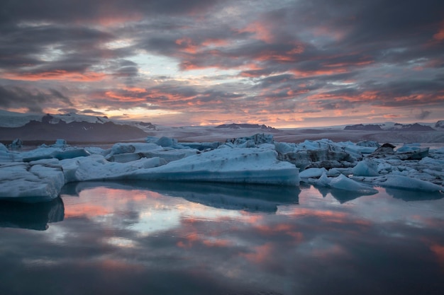 scenic view of icebergs in lake against sky during sunset