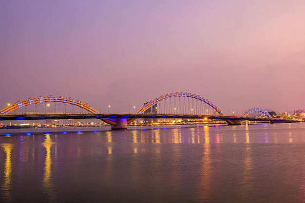 Scenic view of Illuminated Dragon bridge during sunset Danang