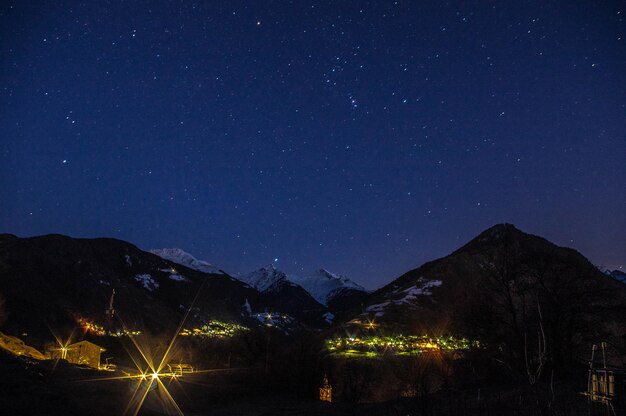 Scenic view of illuminated mountains against sky at night