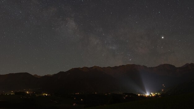 Scenic view of illuminated mountains against sky at night