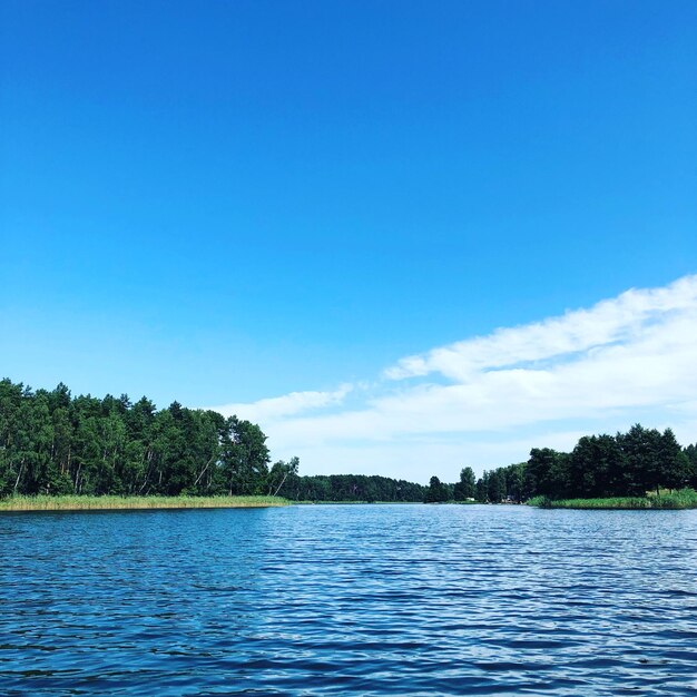 Scenic view of lake against blue sky