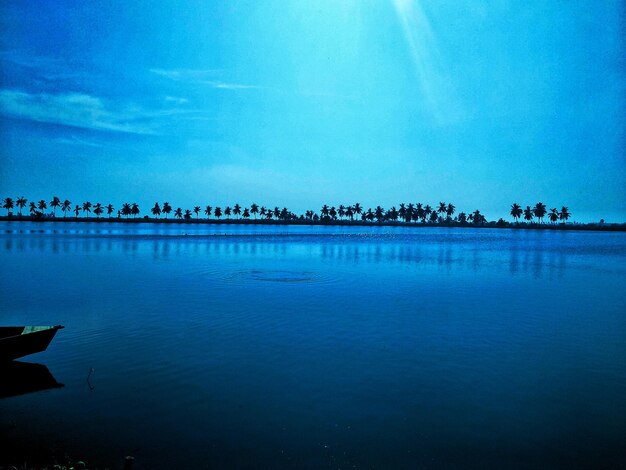 Scenic view of lake against blue sky