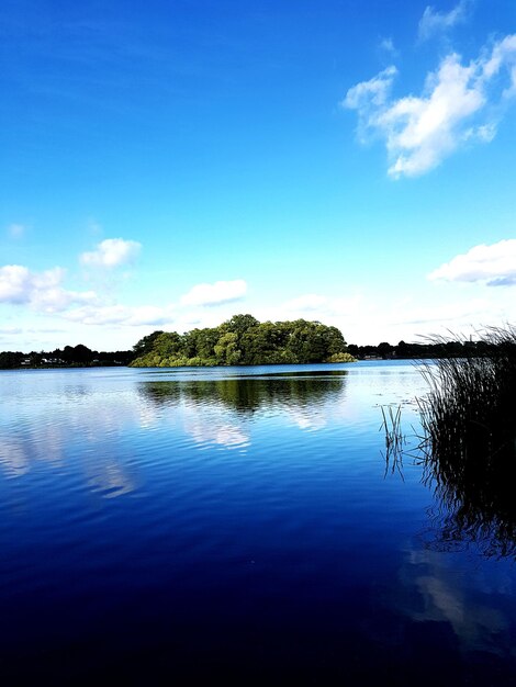 Scenic view of lake against blue sky