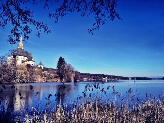 Scenic view of lake against buildings