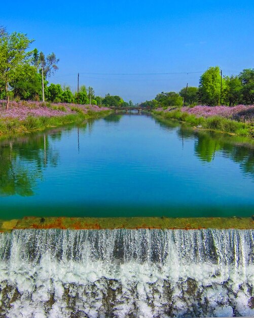 Scenic view of lake against clear blue sky