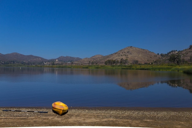 Scenic view of lake against clear blue sky