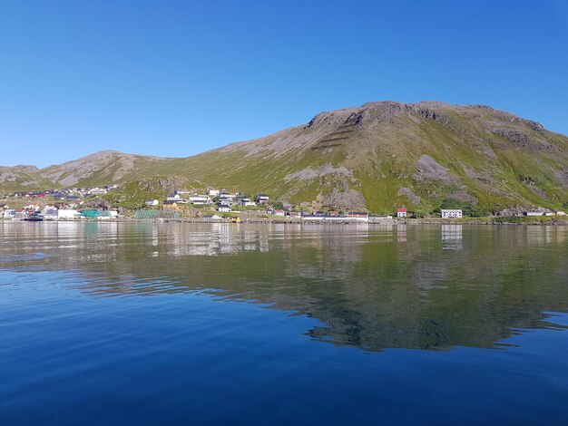 Scenic view of lake against clear blue sky