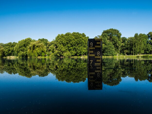 Scenic view of lake against clear blue sky