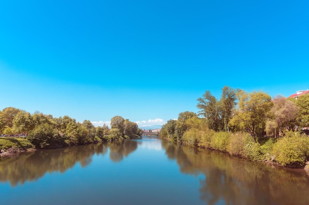 Scenic view of lake against clear blue sky