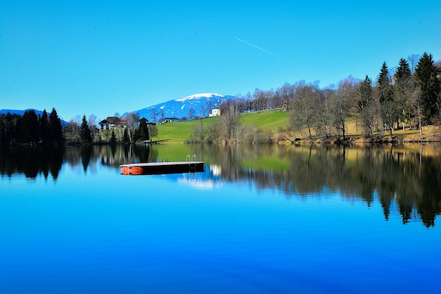 Photo scenic view of lake against clear blue sky