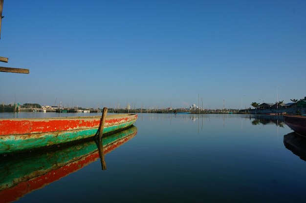 Scenic view of lake against clear blue sky