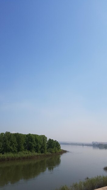 Scenic view of lake against clear blue sky