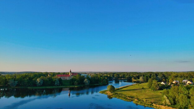 Scenic view of lake against clear blue sky