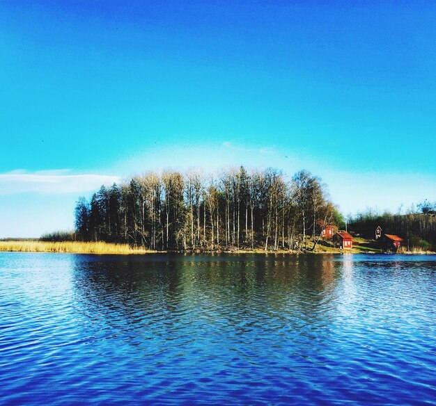 Scenic view of lake against clear blue sky