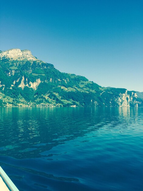 Scenic view of lake against clear blue sky