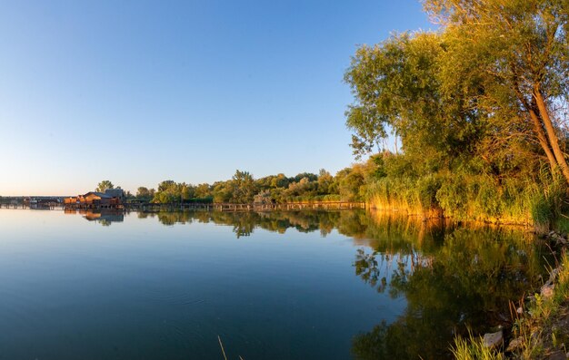 Scenic view of lake against clear sky during autumn