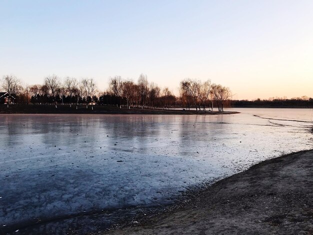 Scenic view of lake against clear sky during winter