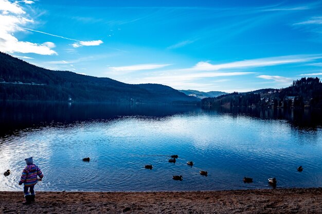 Scenic view of lake against cloudy sky