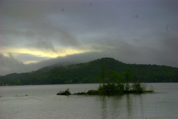 Scenic view of lake against cloudy sky