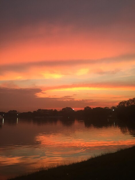 Scenic view of lake against orange sky