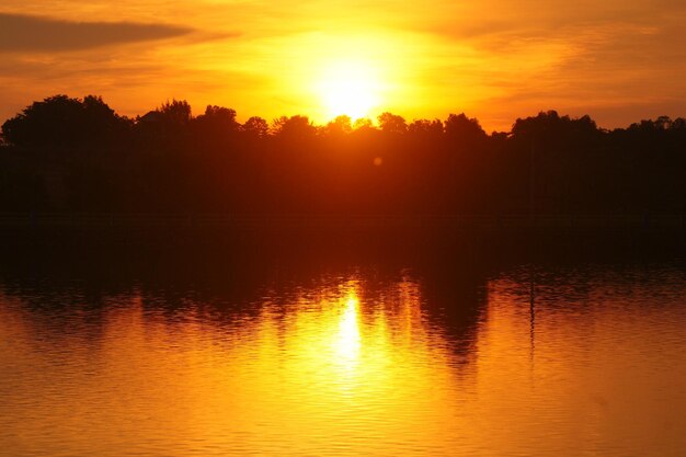 Scenic view of lake against orange sky