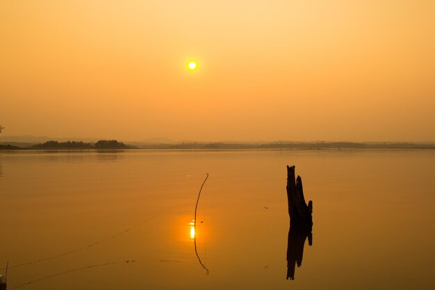 Scenic view of lake against orange sky