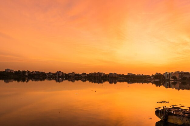 Scenic view of lake against orange sky