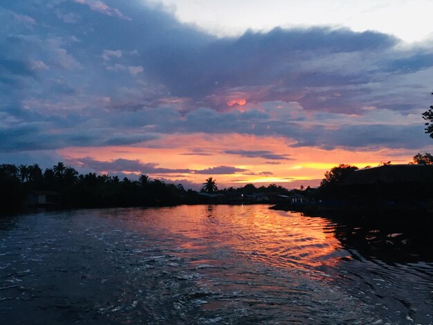 Scenic view of lake against orange sky