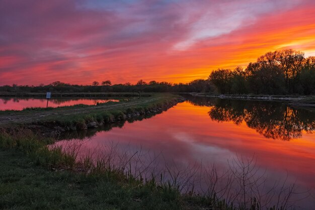 Scenic view of lake against romantic sky at sunset