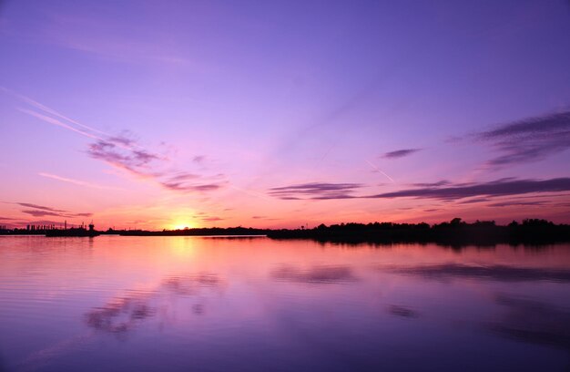 Scenic view of lake against romantic sky at sunset