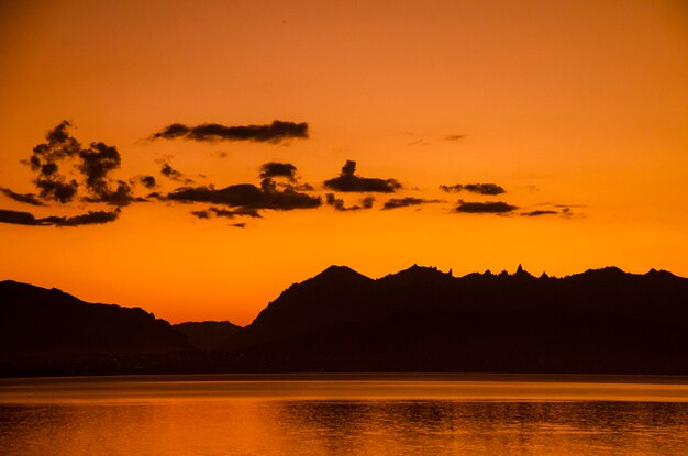 Scenic view of lake against romantic sky at sunset