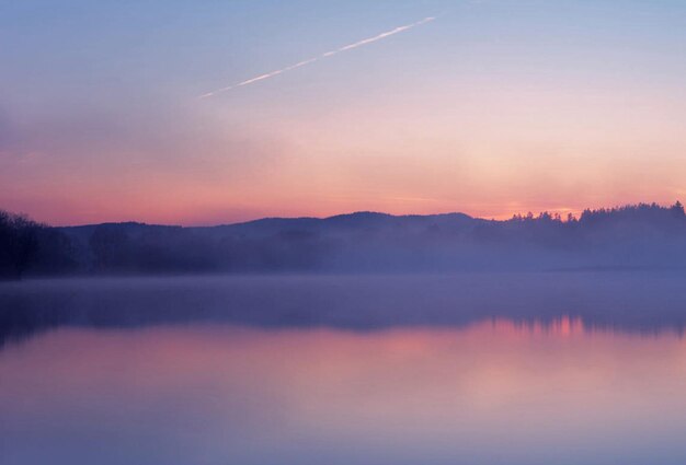 Photo scenic view of lake against romantic sky at sunset